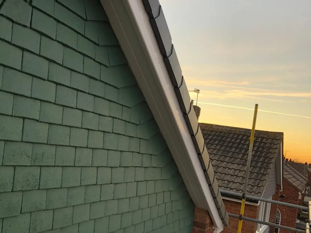 Green cladding on a gable, by AAA Roofing