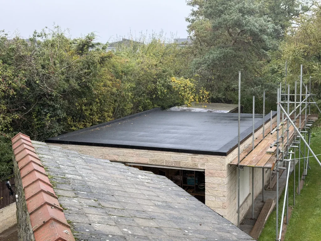 Flat roof beside a slate roof near Runswick Bay