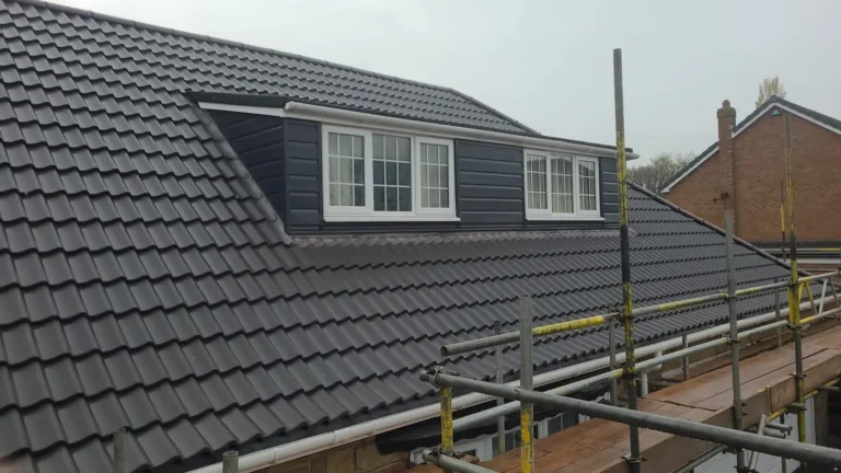 Grey tile re-roof around a dormer